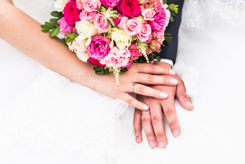 hands-of-groom-and-bride-with-wedding-rings-P2FRNT5.jpg