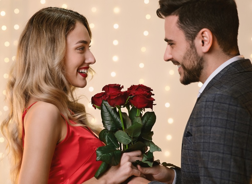 Valentine's Day Flowers. Loving Man Giving Roses To His Happy Girlfriend